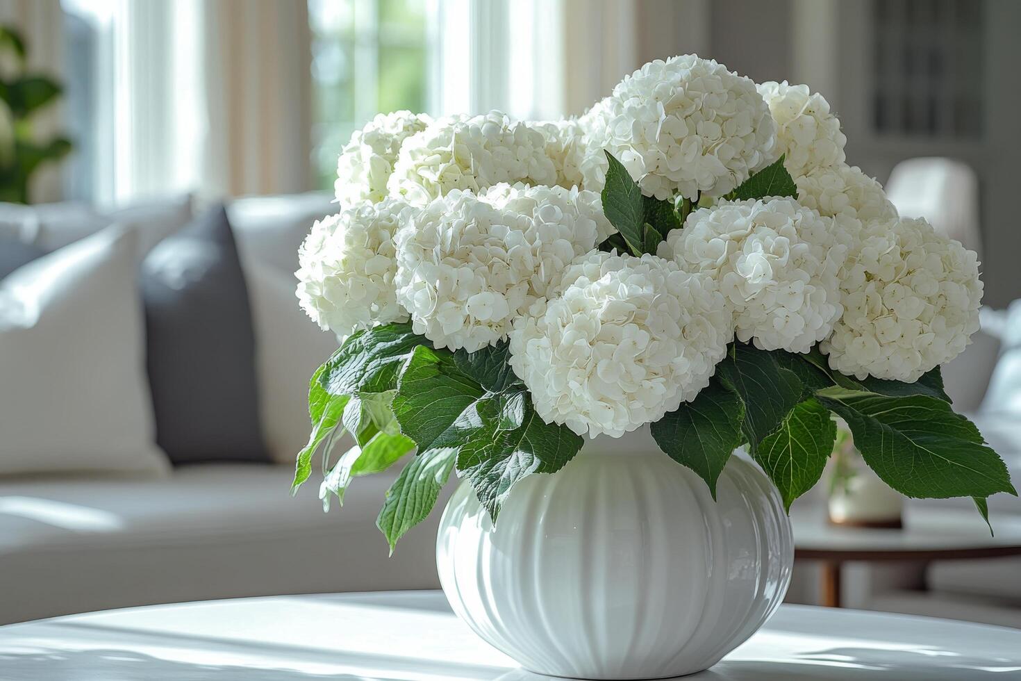 A white vase with white flowers sitting on a table photo
