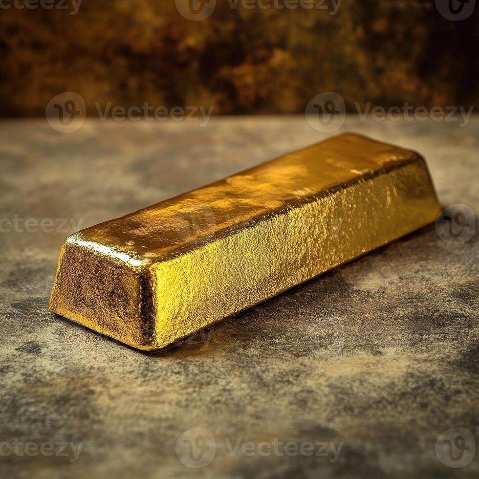 A shiny gold bar sits upon a textured surface photo