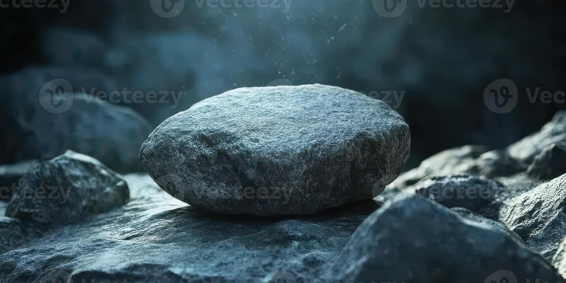 Solitary rock sits prominently on a collection of smaller stones photo