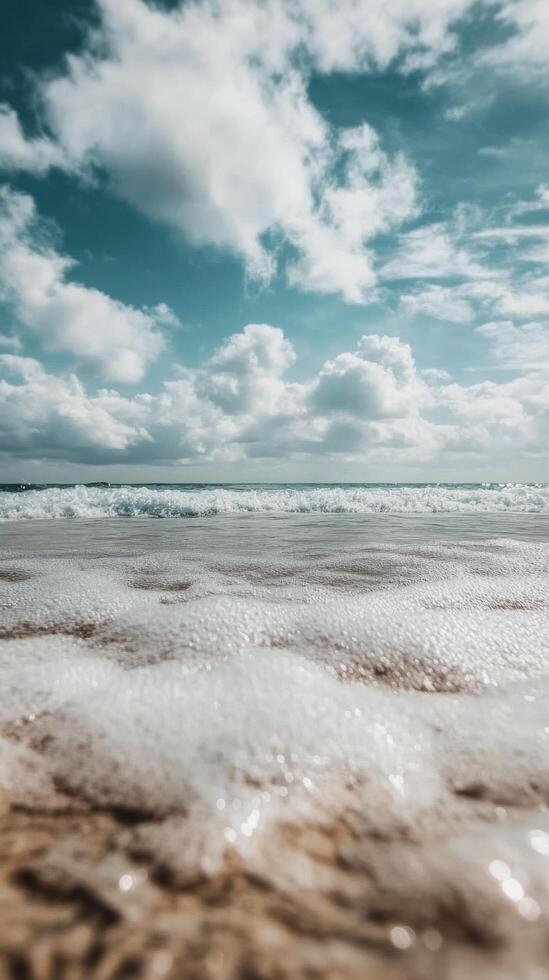 A beach with waves and clouds photo