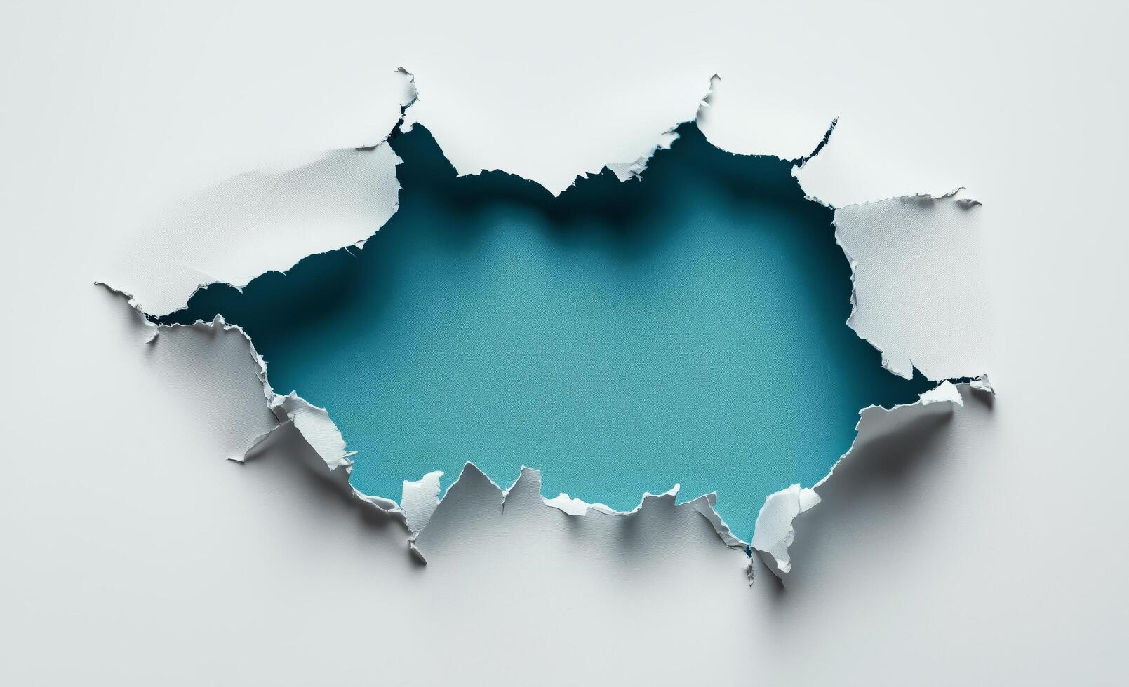 Torn paper reveals bright blue background with jagged edges and texture photo