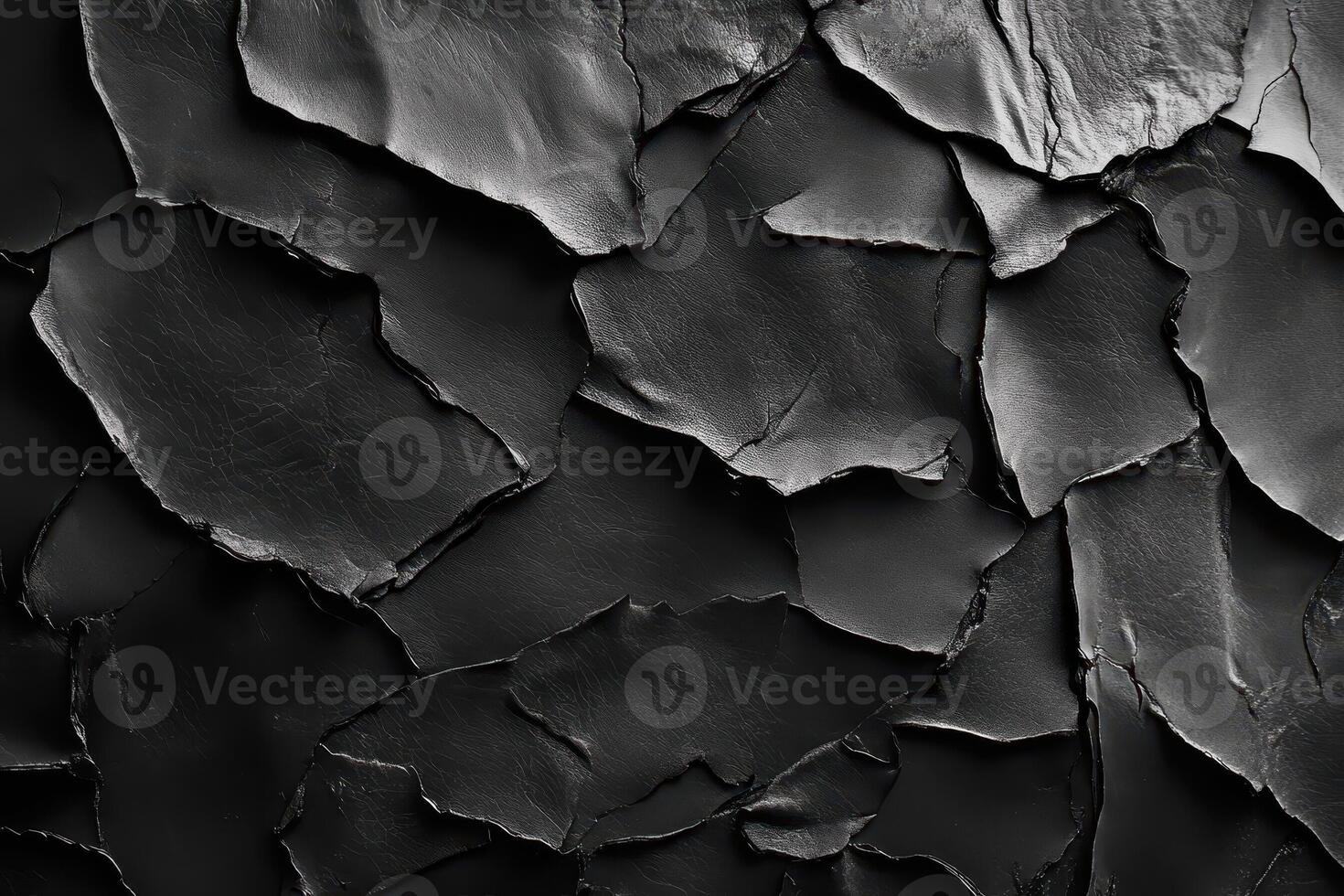 Abstract composition of dark flaky textured surface in close up photo