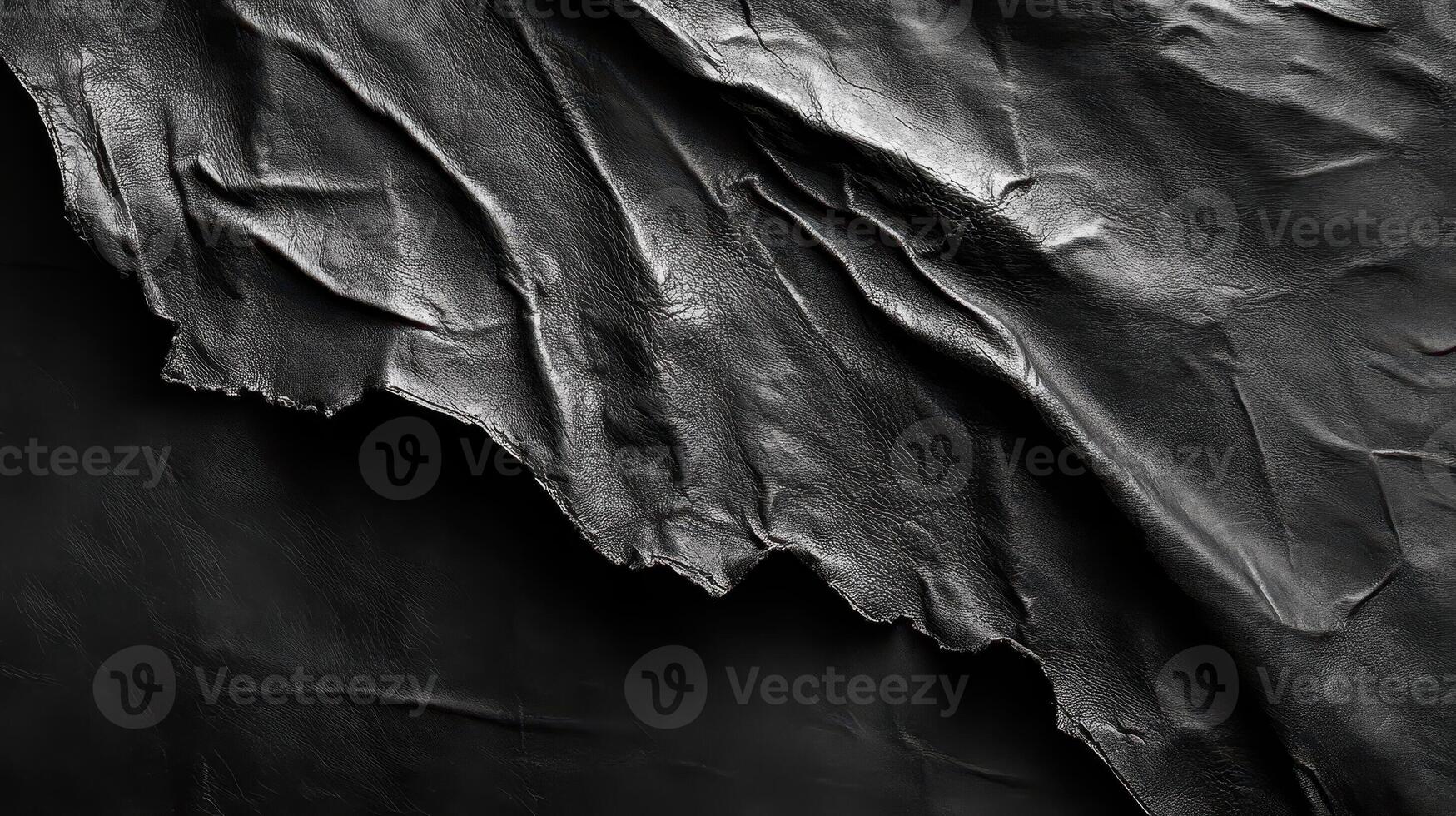 Tattered textured dark leather material creating an abstract background photo