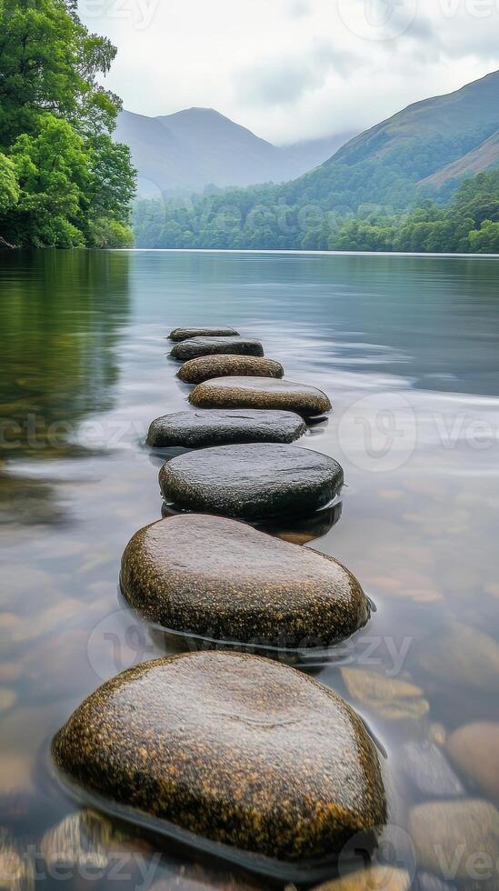 Stepping stones create a path across the tranquil lake surface photo