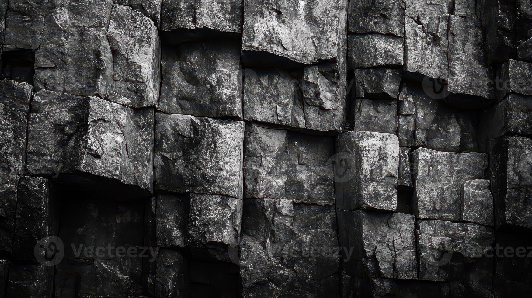 Dark basalt columns form a rugged and geometric natural wall photo