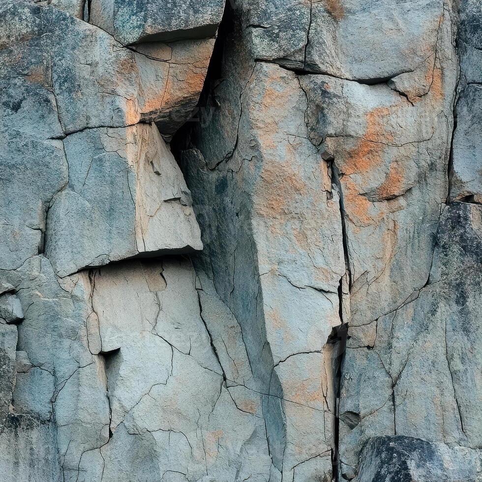 Fragmented rock face with cracks and subtle color variations photo