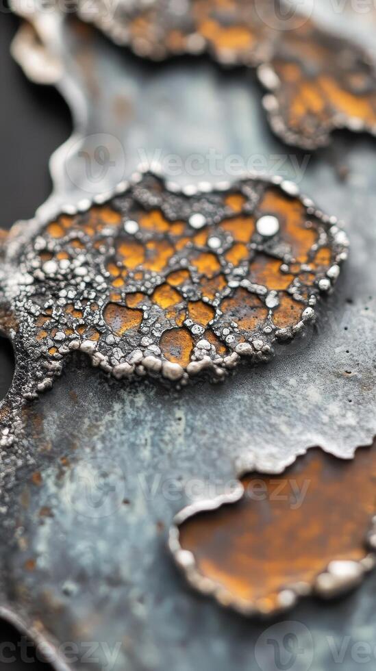 Close up of textured metalwork with orange and silver hues photo