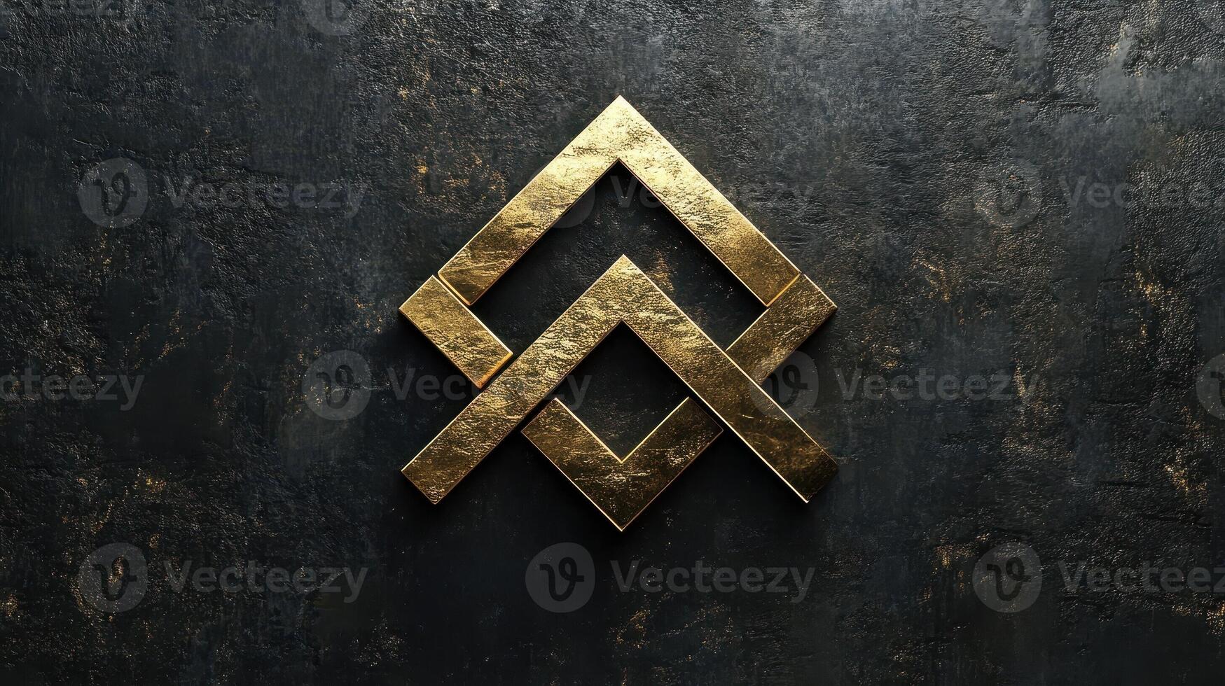 Golden interlocking geometric shapes rest on a dark stone surface photo