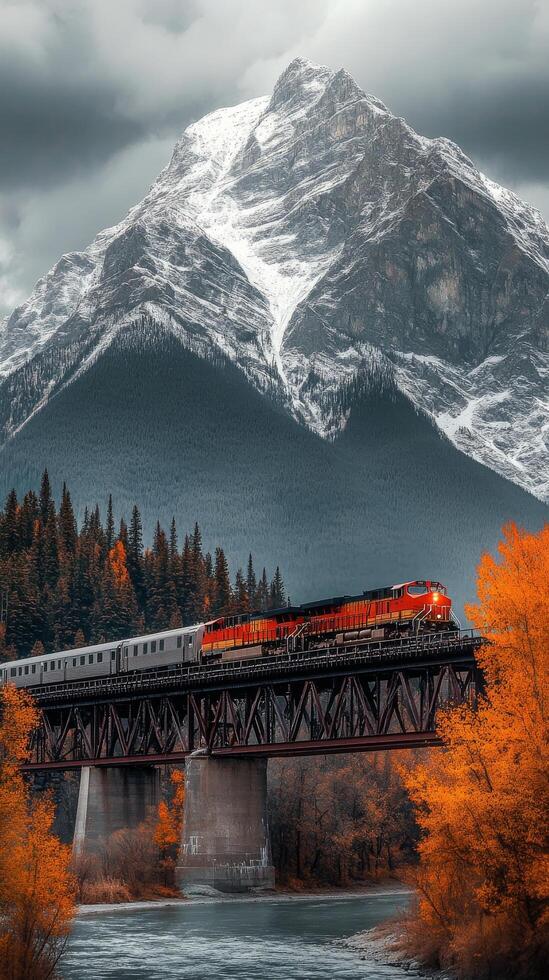 A train traveling over a bridge in the mountains photo