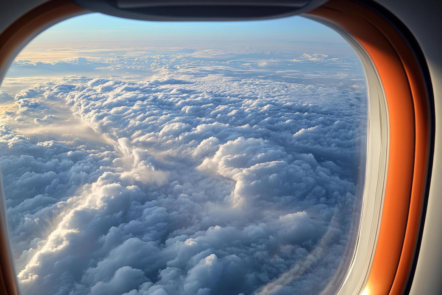 An airplane window view of clouds and sky photo