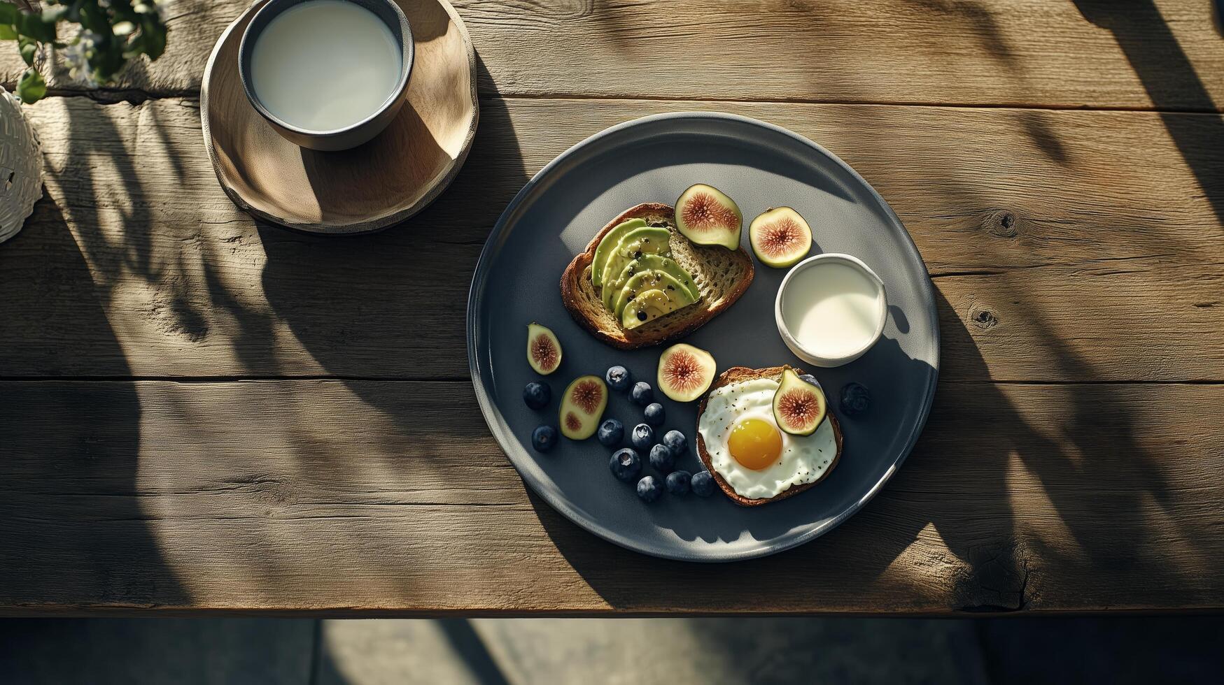 Healthy breakfast featuring eggs, figs, blueberries, and toast served with milk on a rustic wooden table photo