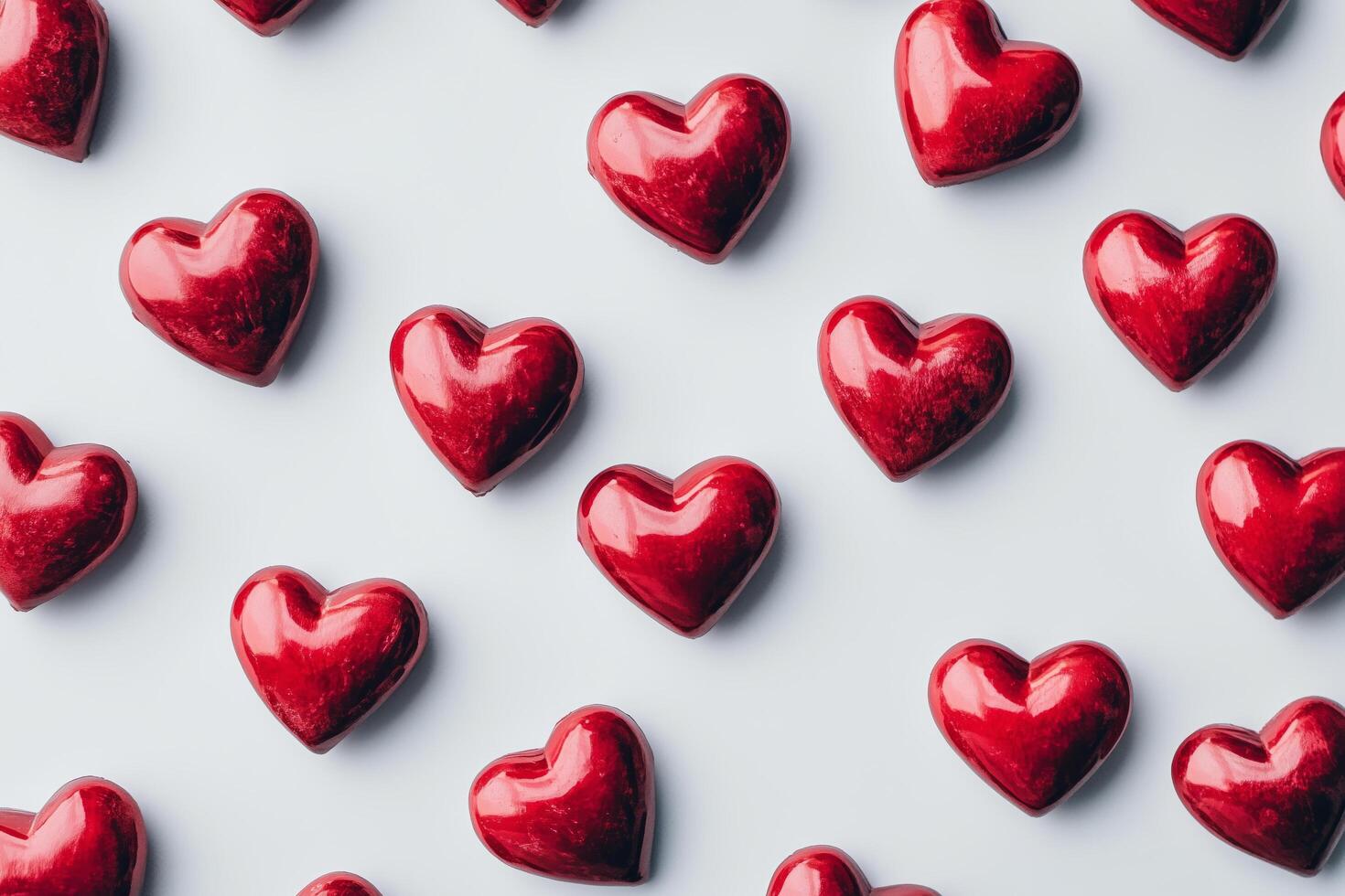 Red heart shapes arranged creatively on a light background for decoration or celebration photo