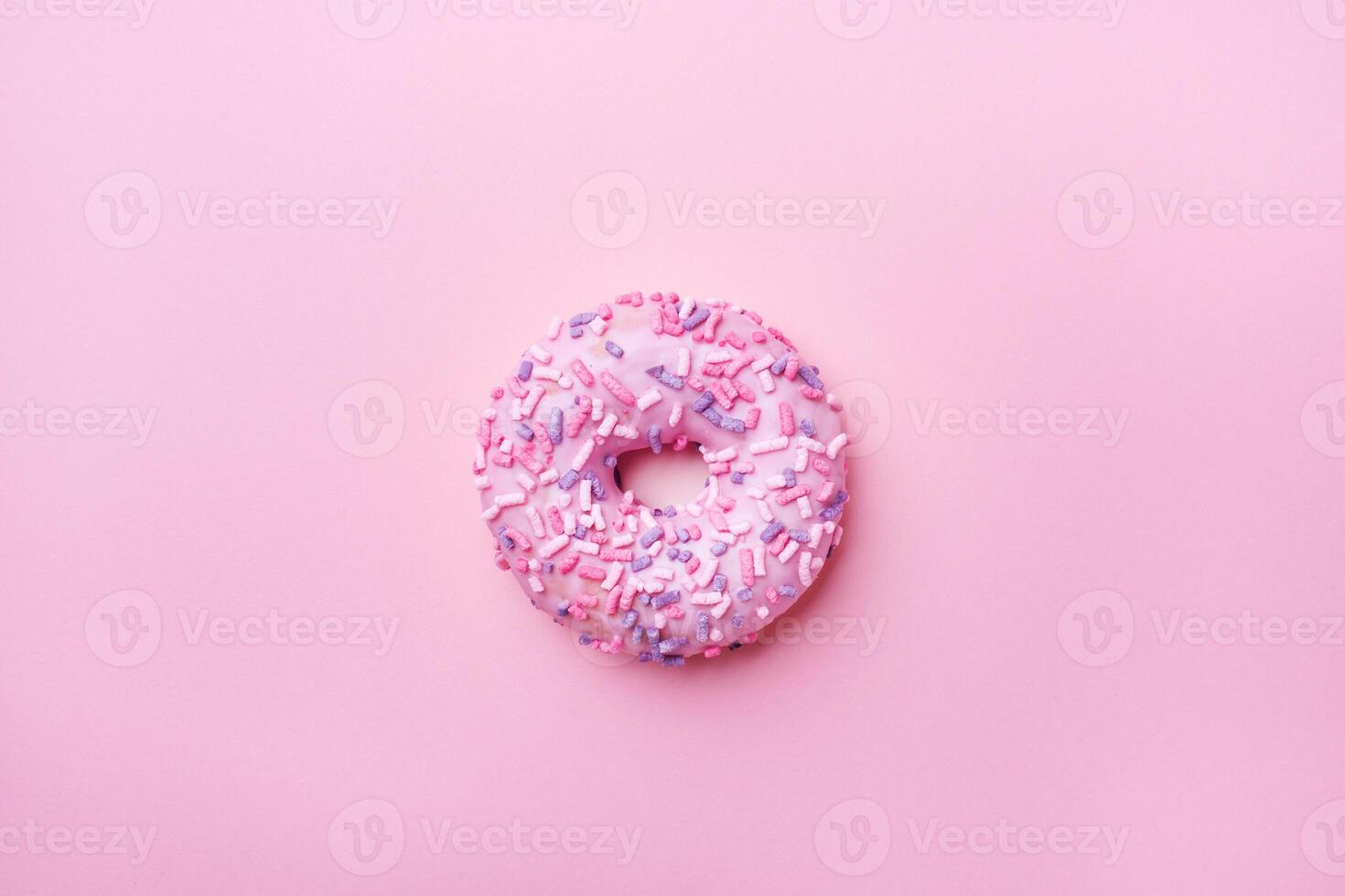 Pink doughnut on a pink background. photo