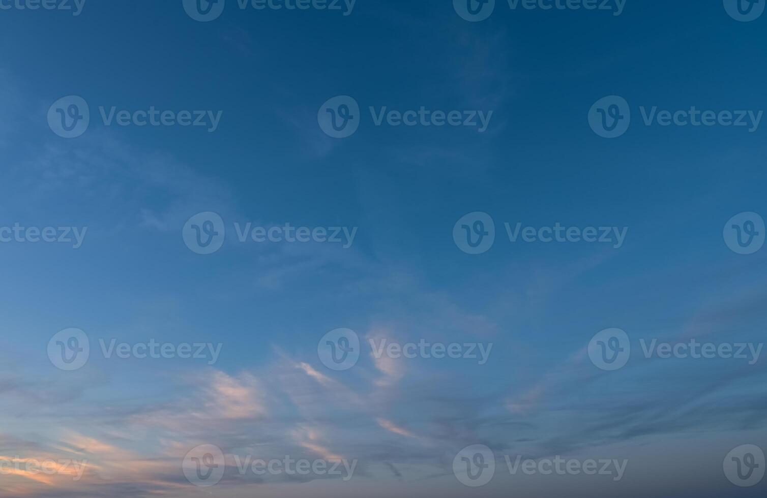 Expansive twilight sky reflecting soft hues at the edge of a tranquil evening photo