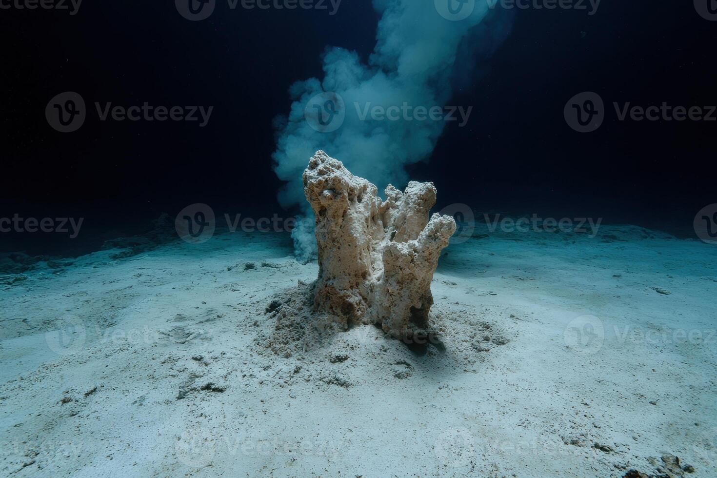 Underwater hydrothermal vent spewing smoke on the ocean floor photo