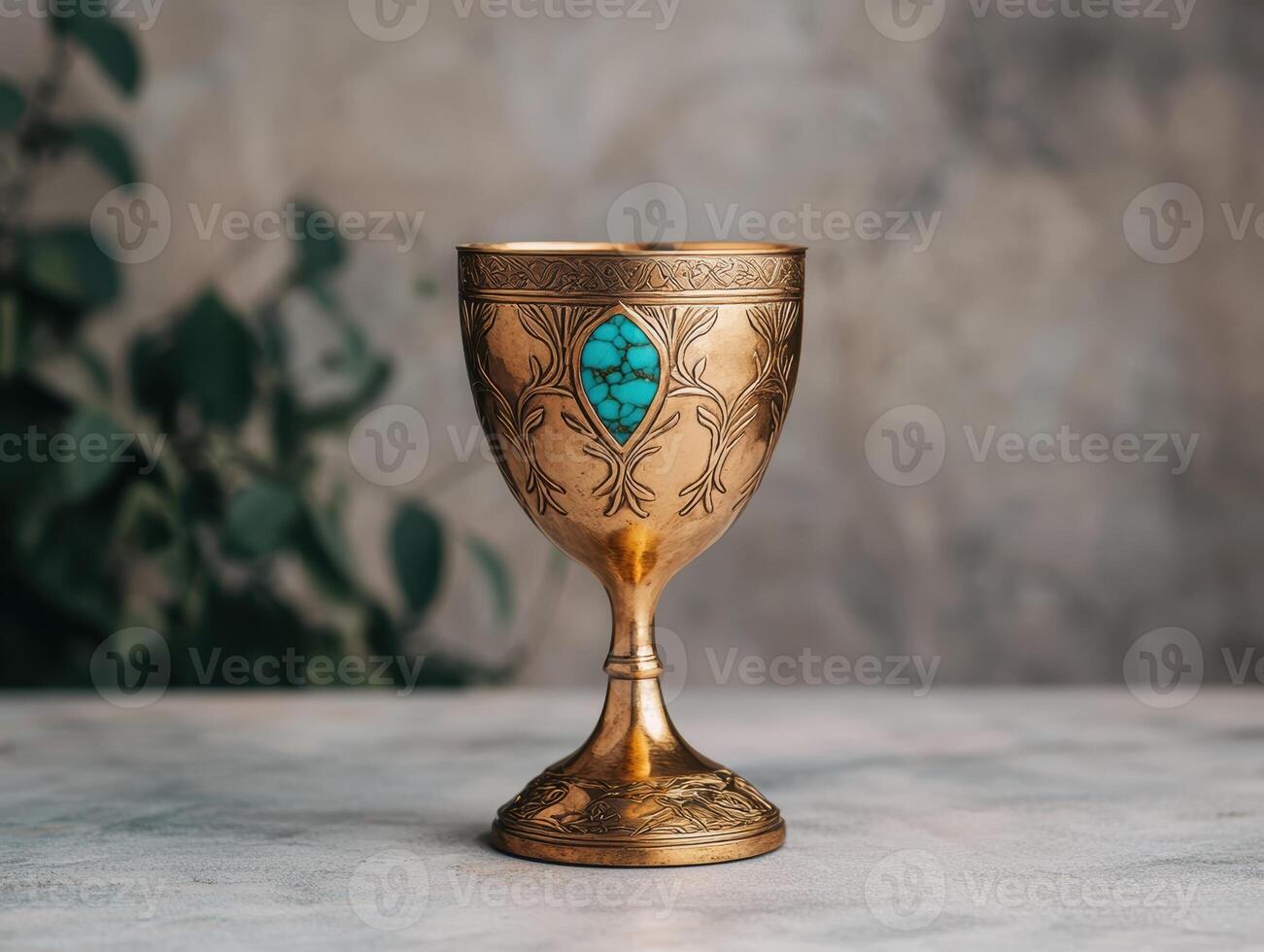 Ornate golden goblet with turquoise gemstone. photo