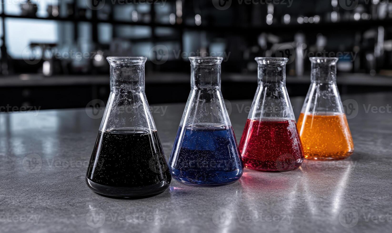 Four beakers filled with different colored liquids on a table photo