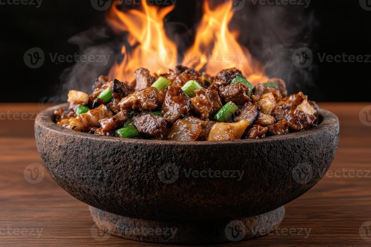 A bowl of delicious, steaming hot stir fry with flames in the background photo