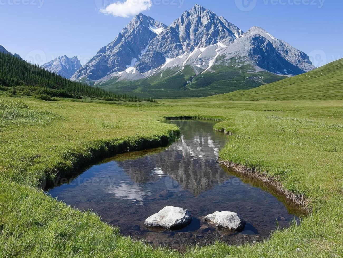 Scenic mountain landscape with a stream reflecting the peaks photo