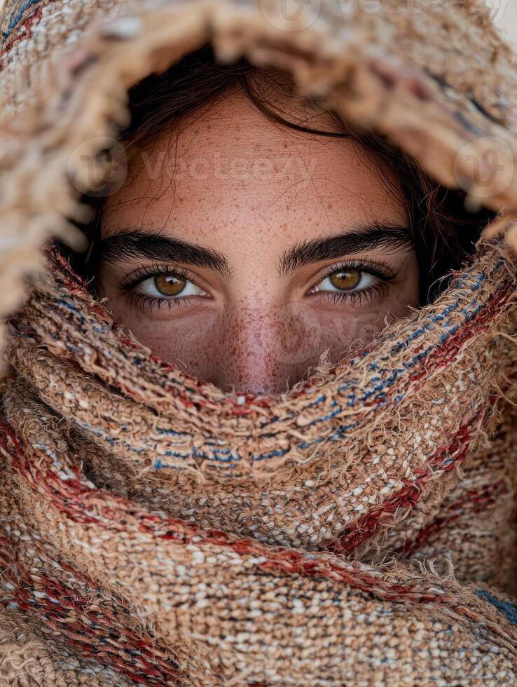 Close up portrait of a woman wrapped in a textured shawl photo