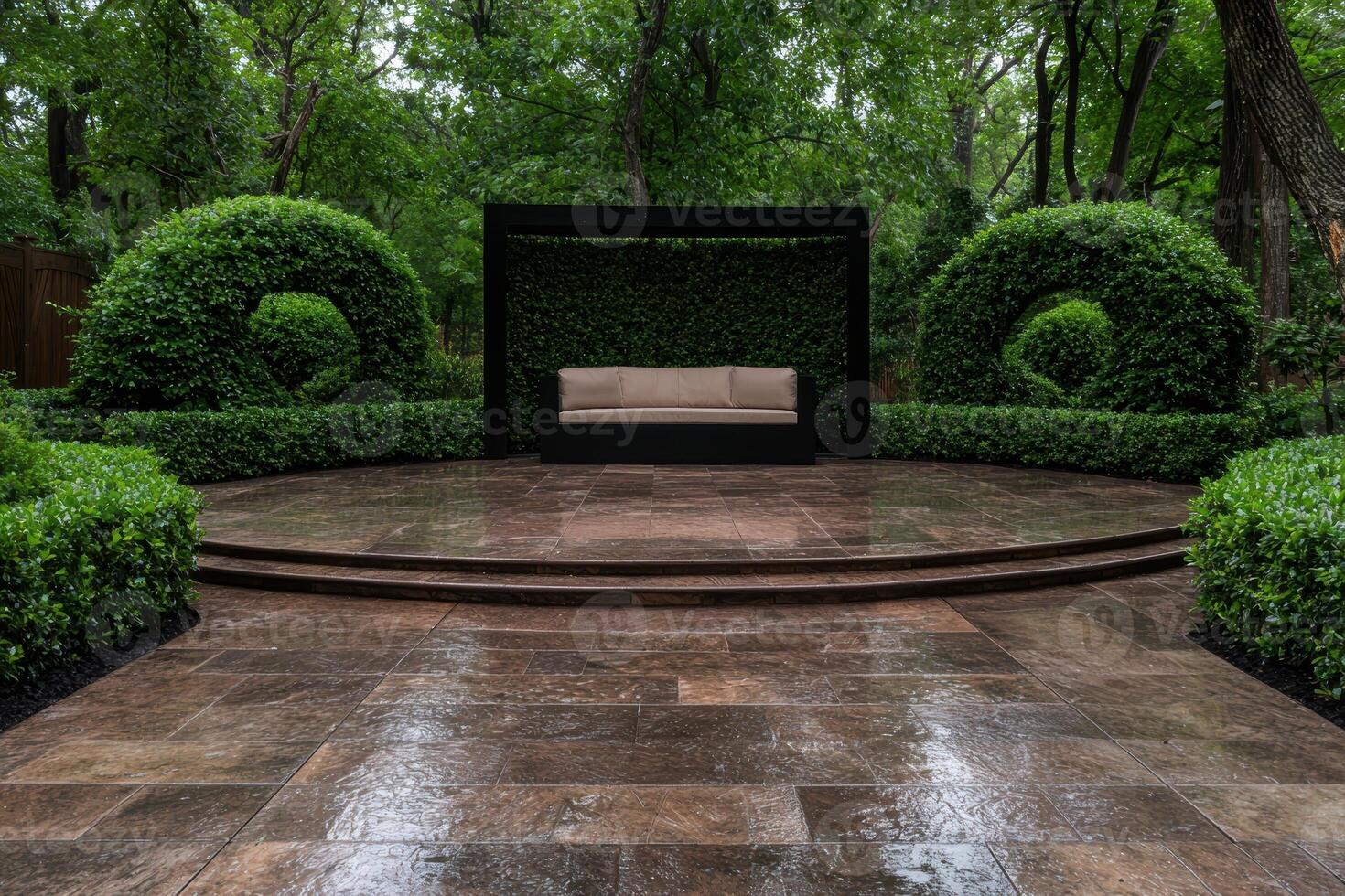 A tranquil outdoor seating area with manicured hedges and a comfortable couch photo