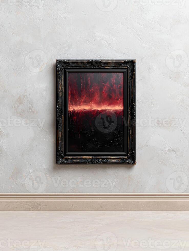 Abstract painting with red horizon in a dark frame hanging on a wall photo