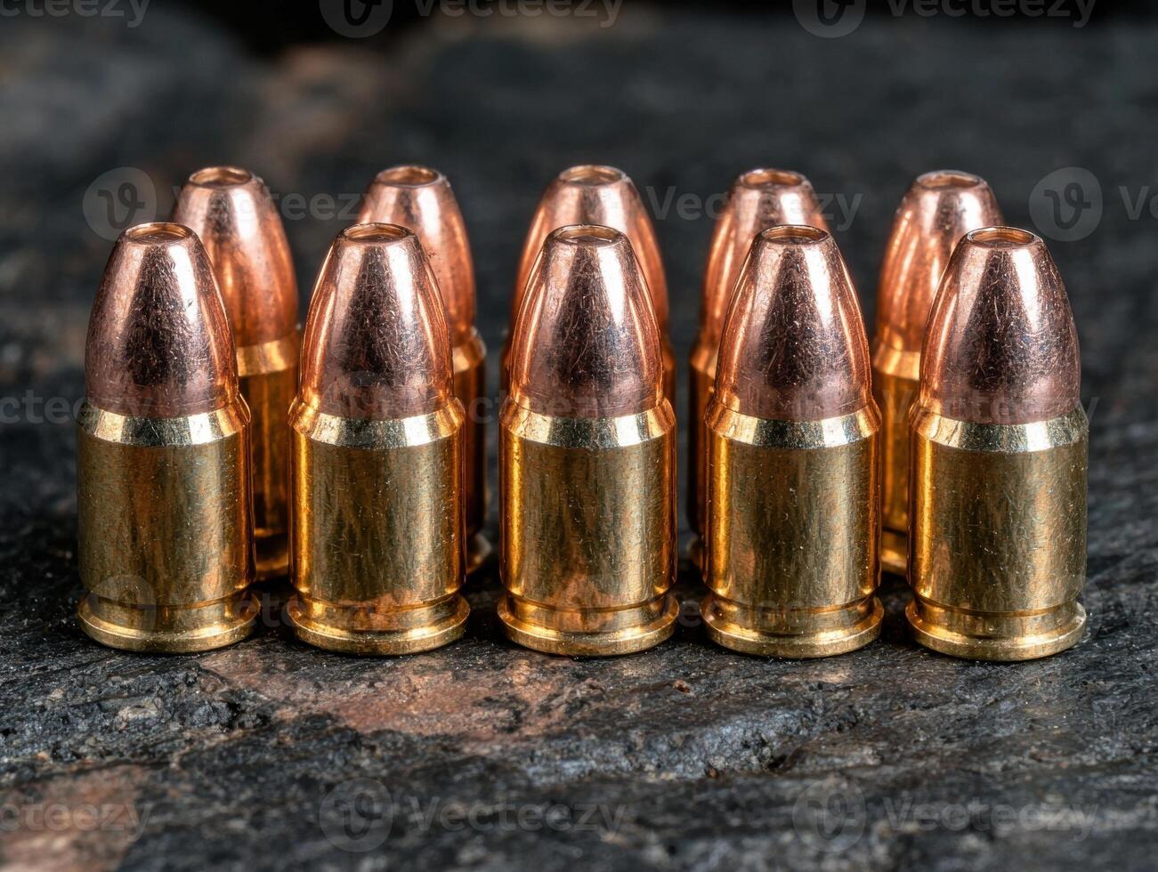 Ammunition lined up on a dark surface photo