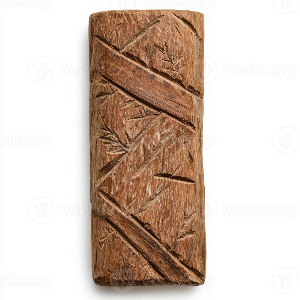 A carved wooden block with a leaf pattern photo