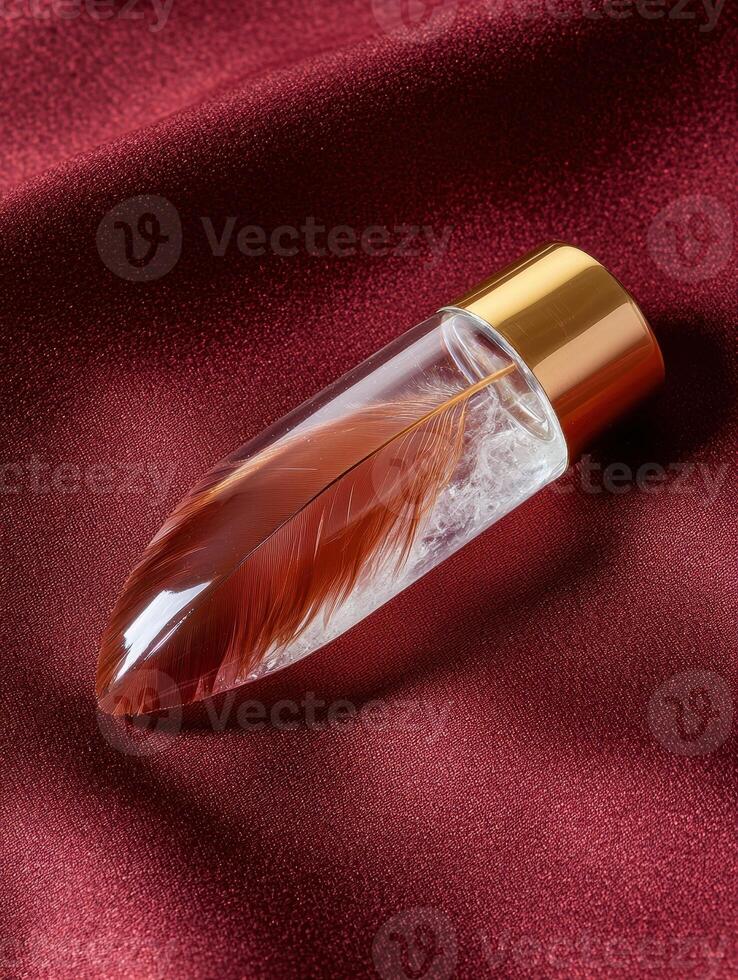 Feather encased in glass on a red silk background photo