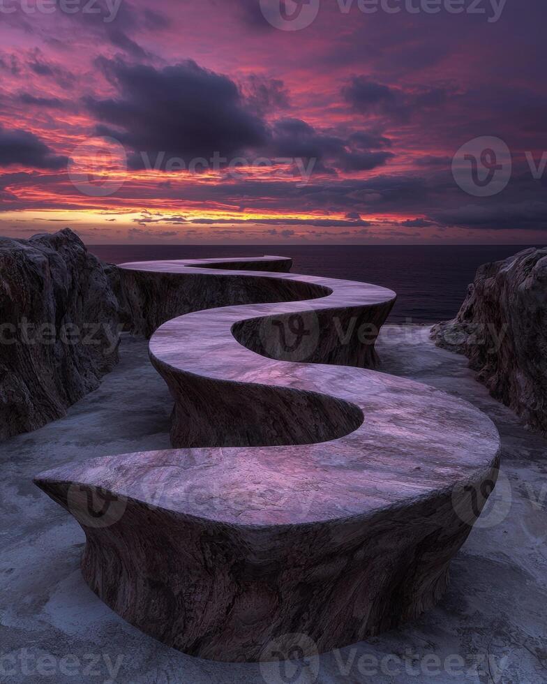 Dramatic sunset over a winding stone path on a cliff edge photo
