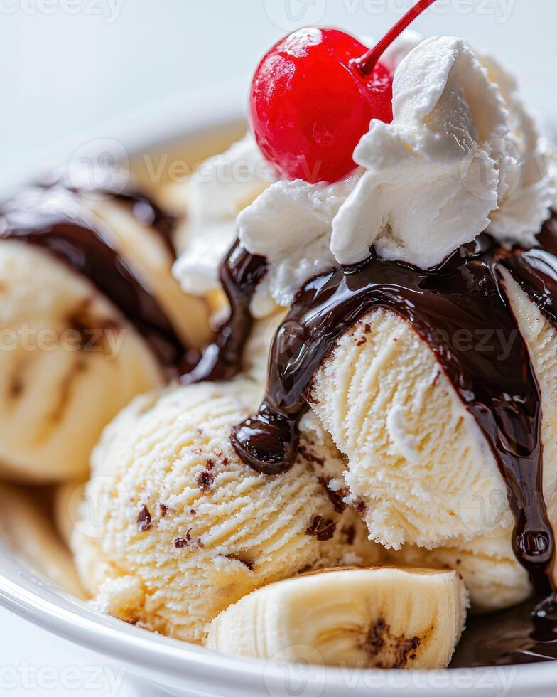 A delicious banana split with vanilla ice cream, chocolate sauce, whipped cream, and a cherry on top photo
