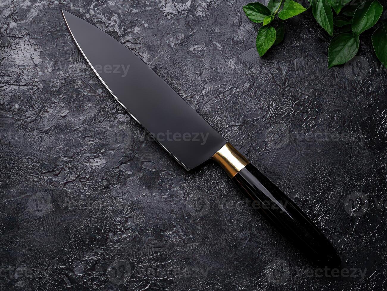A sharp chefs knife on a dark textured surface photo