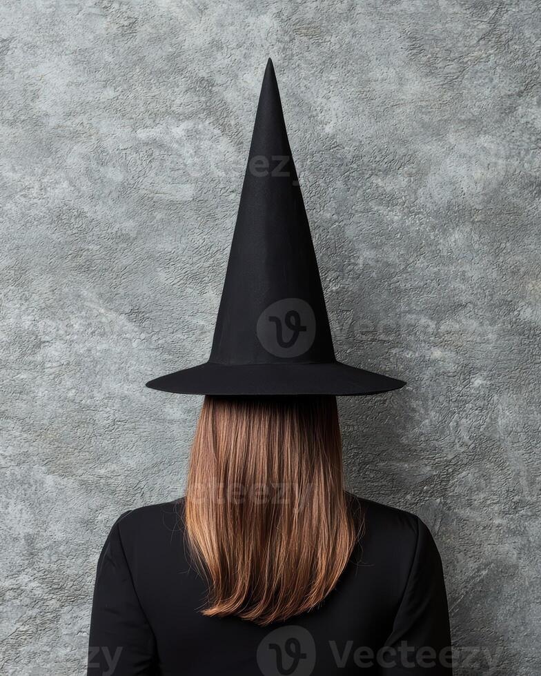 A person wearing a witchs hat from behind photo