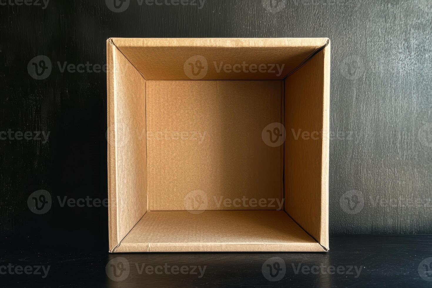 Empty cardboard box on a dark surface photo