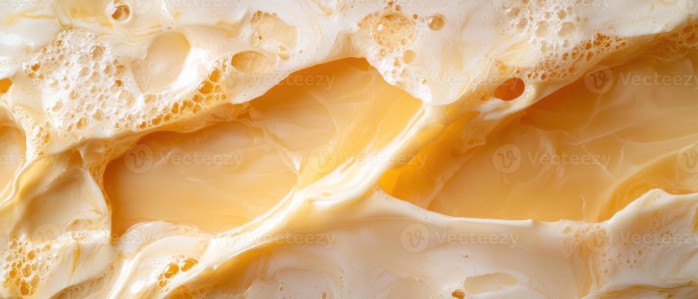 Close up of frothy golden liquid with bubbles photo