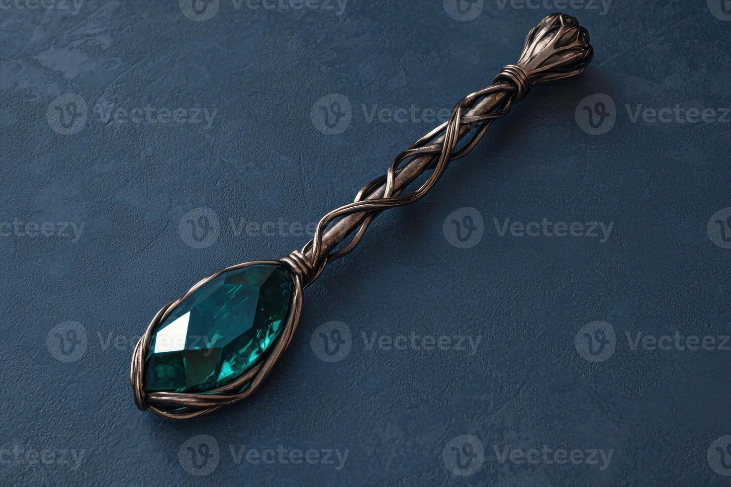 A decorative silver spoon with a large green gemstone photo