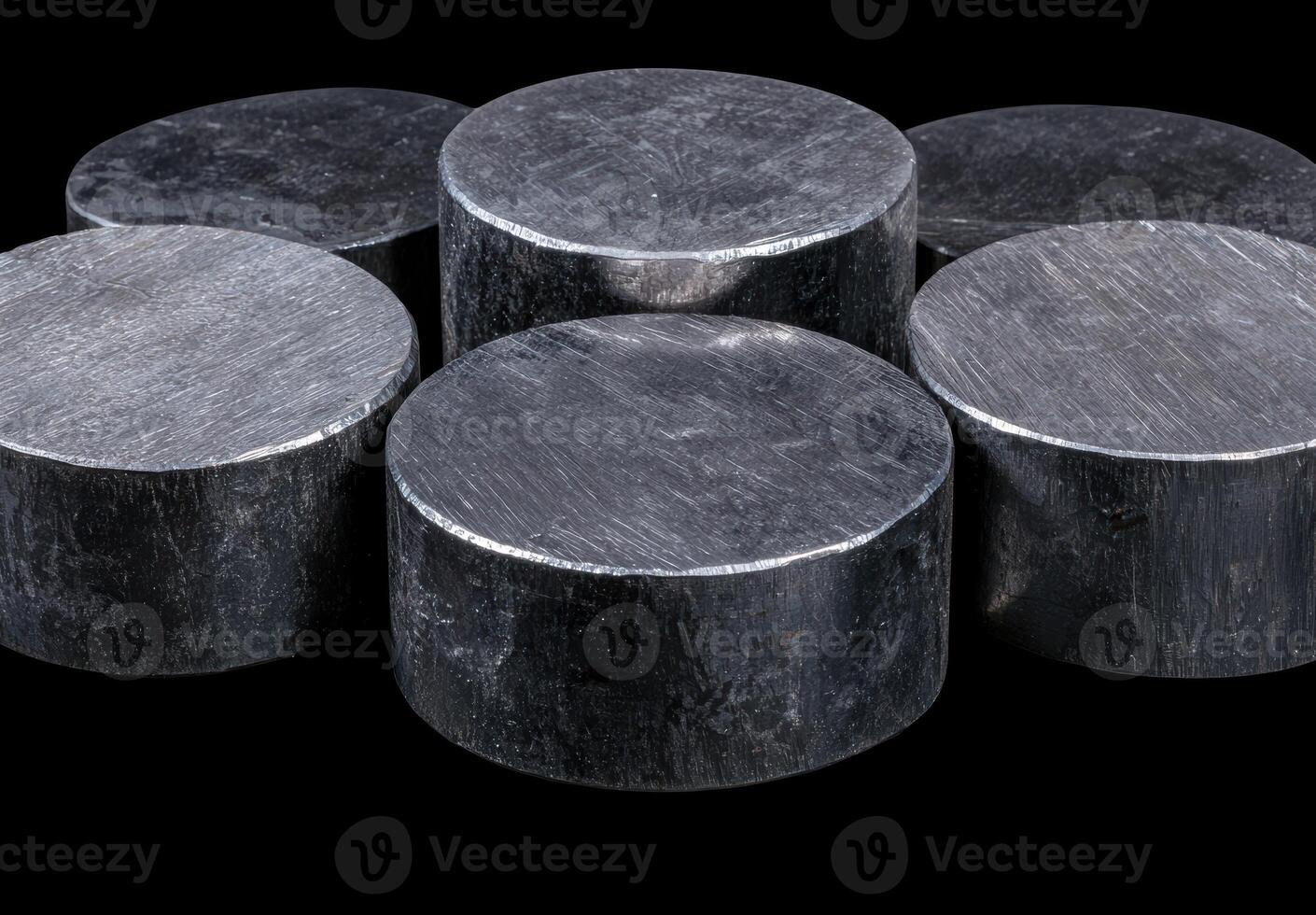 Stack of metallic cylinders on a black background photo
