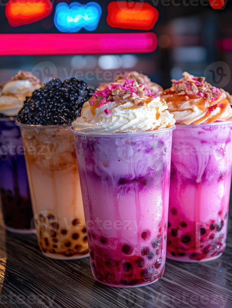 Colorful bubble tea drinks with tapioca pearls and whipped cream photo