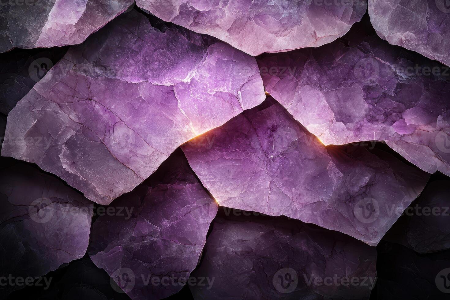 A close up of amethyst stones with light shining through the cracks photo