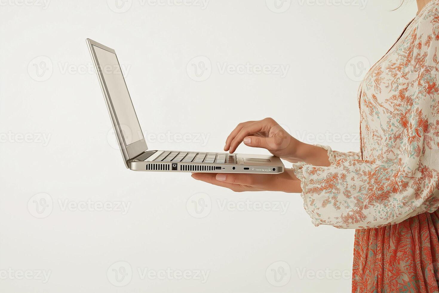 A woman holding a laptop computer photo