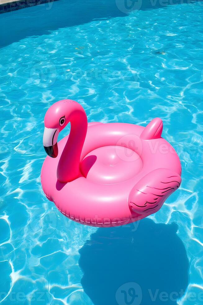 A vibrant flamingo float drifting in a pool under the sun photo