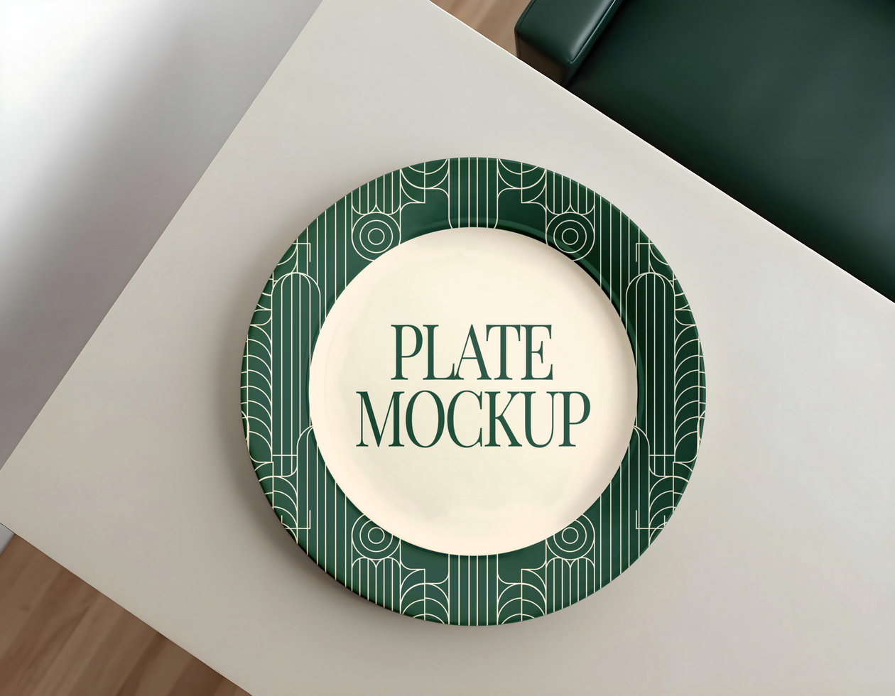 A green and cream patterned plate sits on a light grey table psd