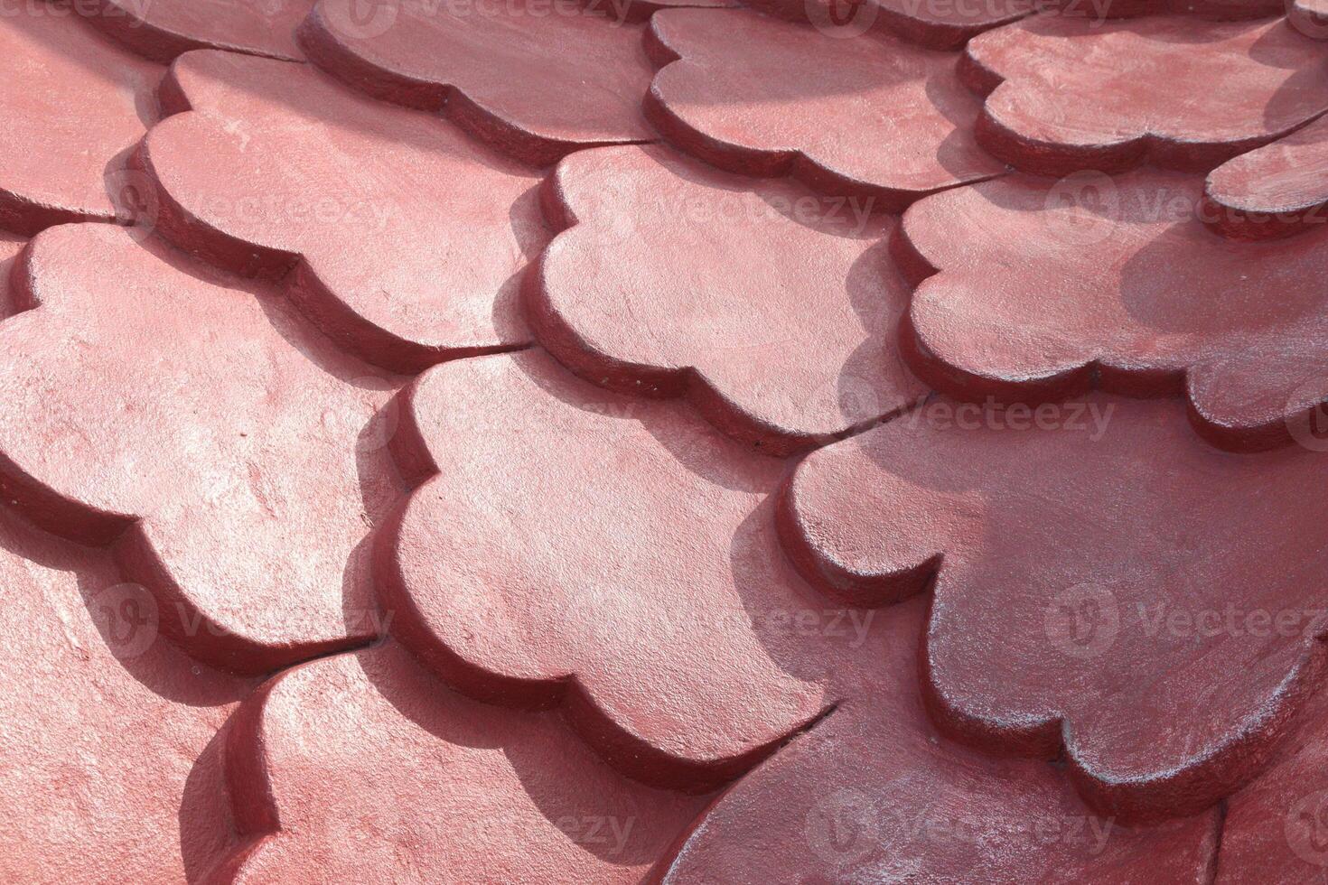 A close up of a red tile roof with a heart shape photo