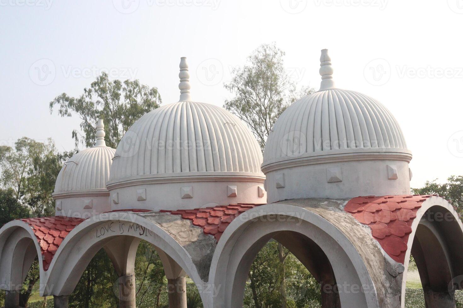 A white dome with red tiled roof photo