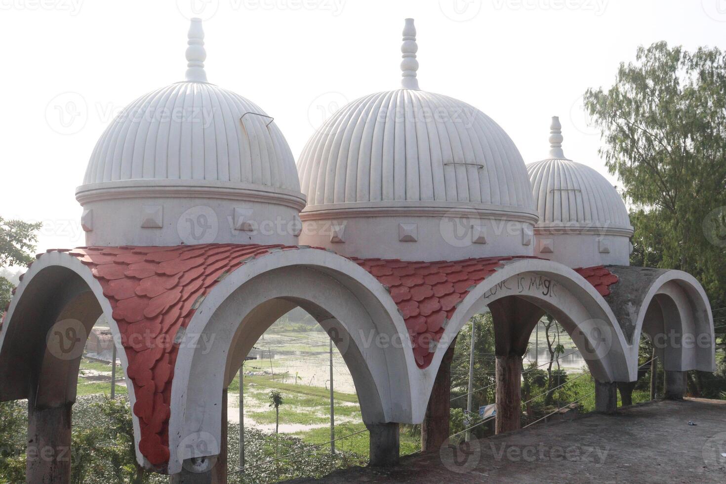 A large white dome with red roof on top of a building photo