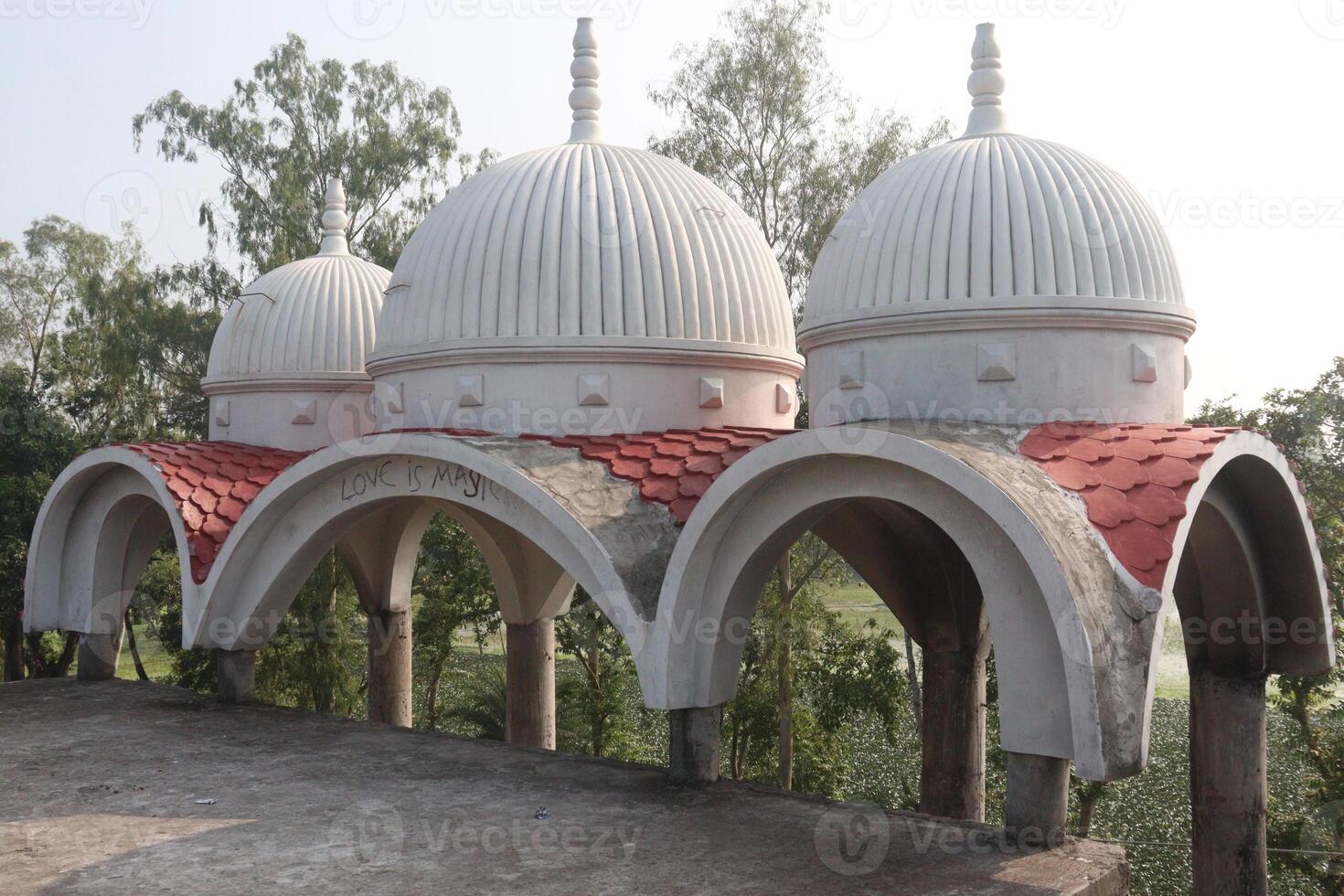 A large white building with red and white domes photo