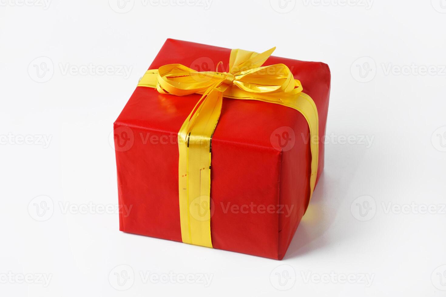 Portrait photo of red gift box with yellow gold ribbon for Christmas
