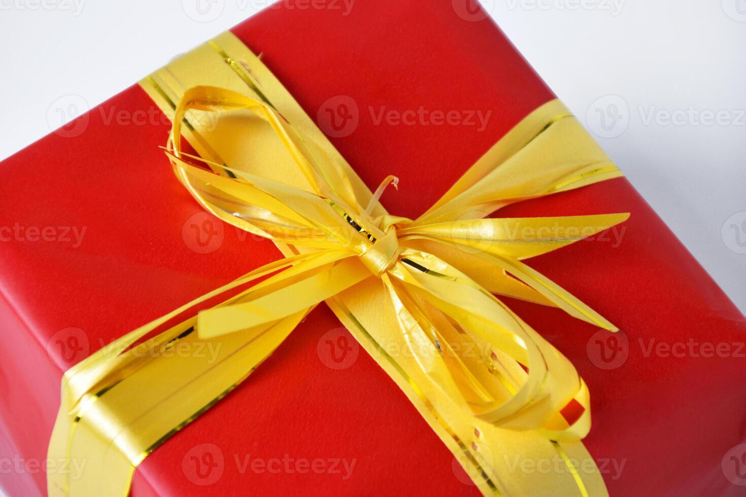 Top view and closeup shot of a red gift box with a yellow ribbon photo