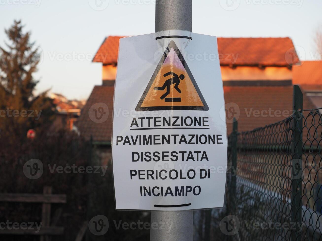 attention uneven pavement danger of tripping sign photo