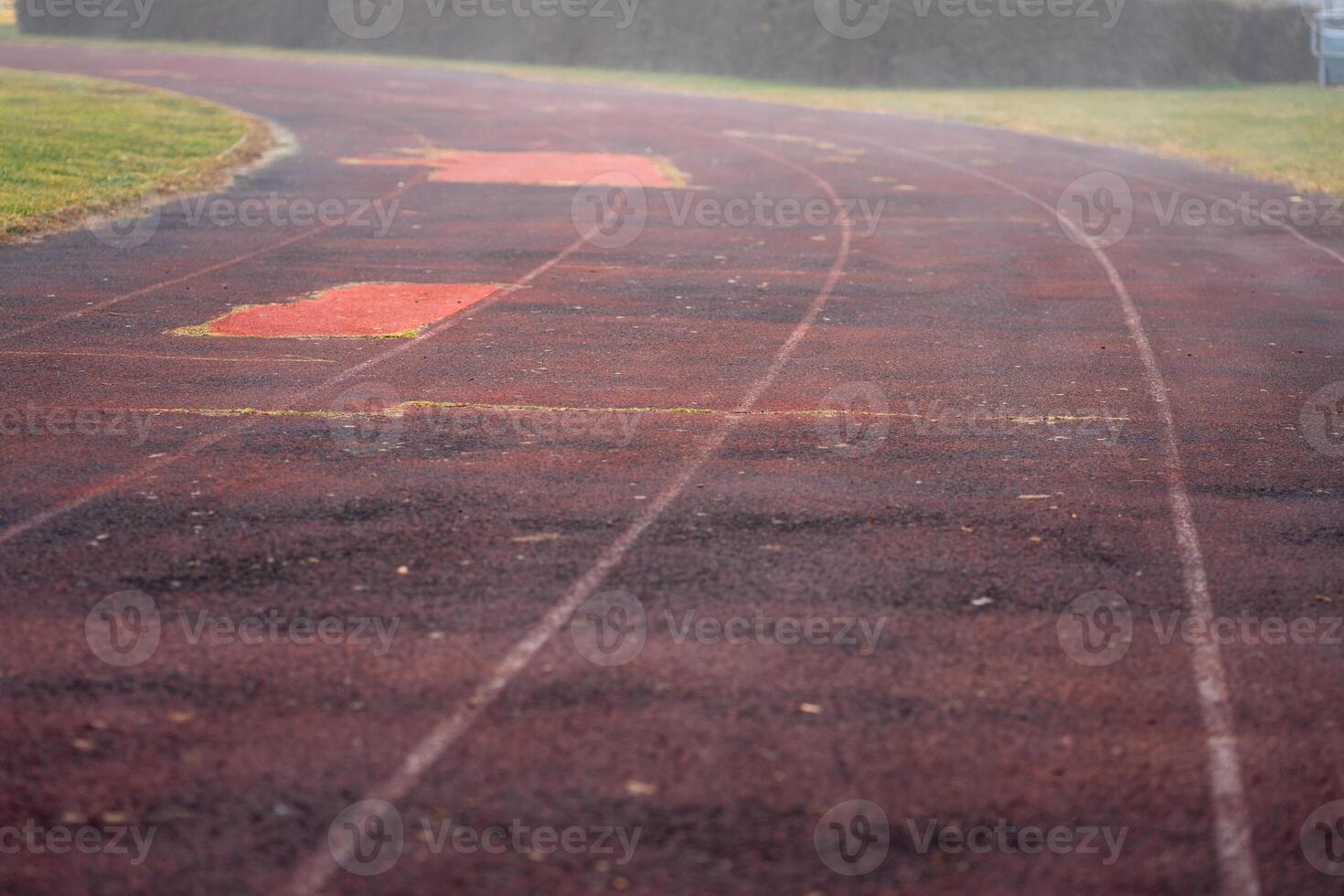 View of an old running track at a street stadium in the early morning photo